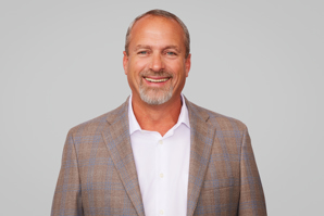 A portrait of a man in a white shirt and a suit jacket.