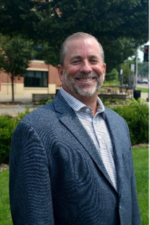 A professional portrait of a man in a suit